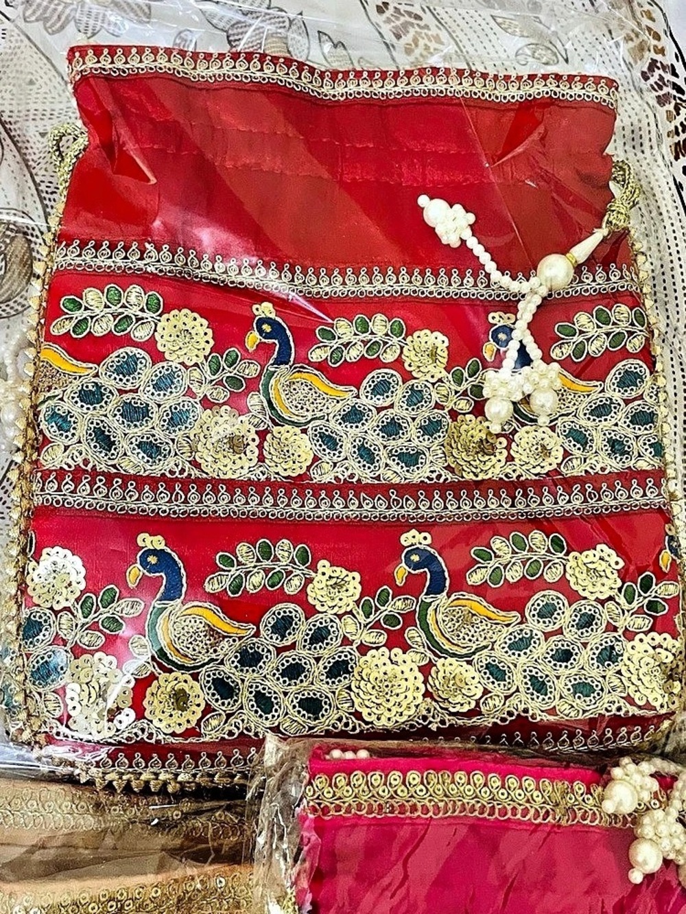 Embroidered peacock potli bag with pearl accents